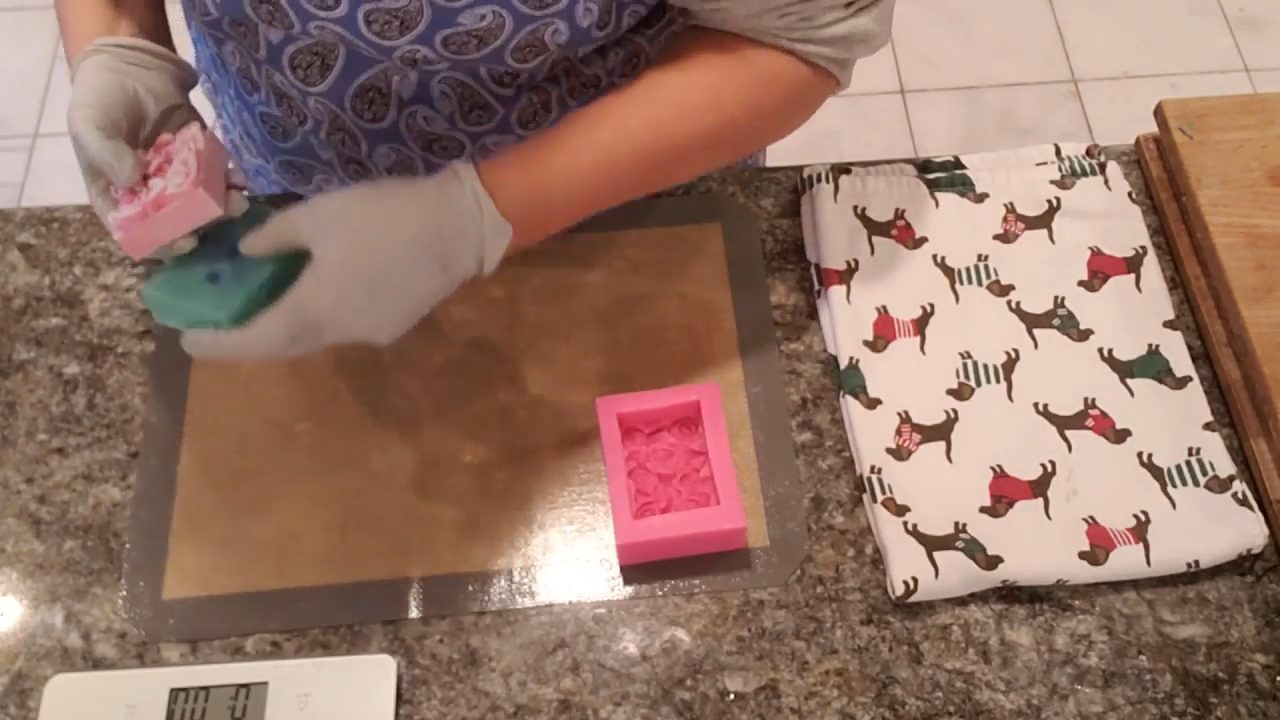 Finished rose swirl soap next to a regular bar for comparison