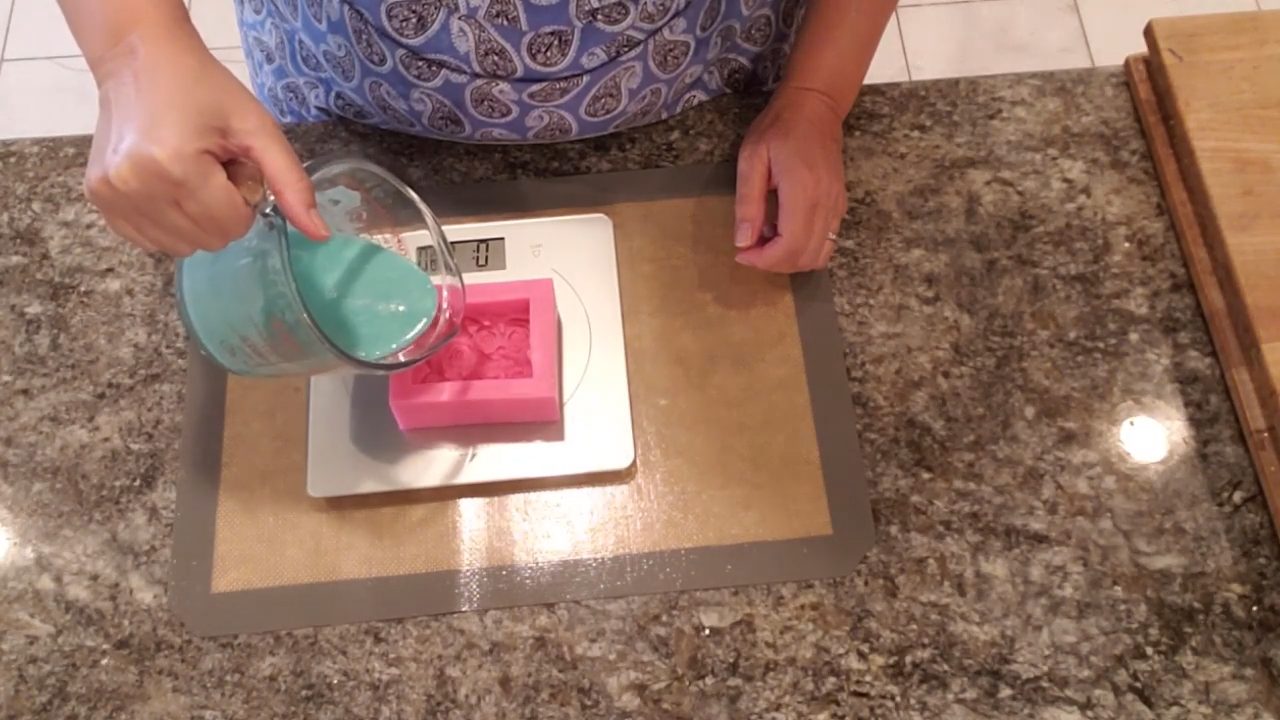 Measuring how much melted soap a rose bar mold holds on a scale