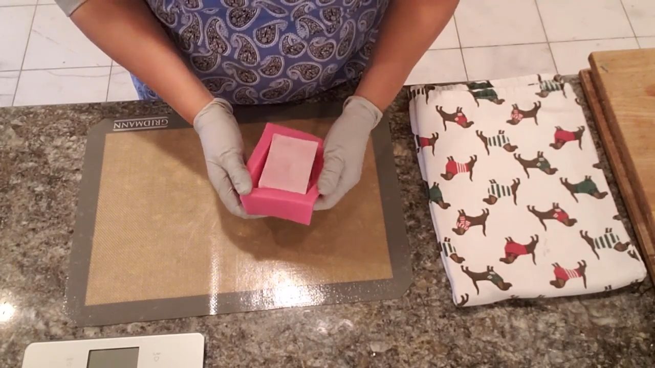 Unmolding a pink rose swirl melt and pour soap bar