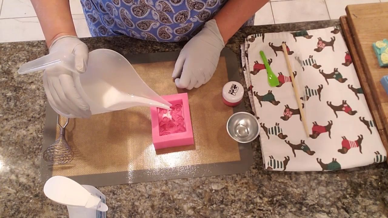 Swirling a thin coat of white shea butter soap into the rose mold