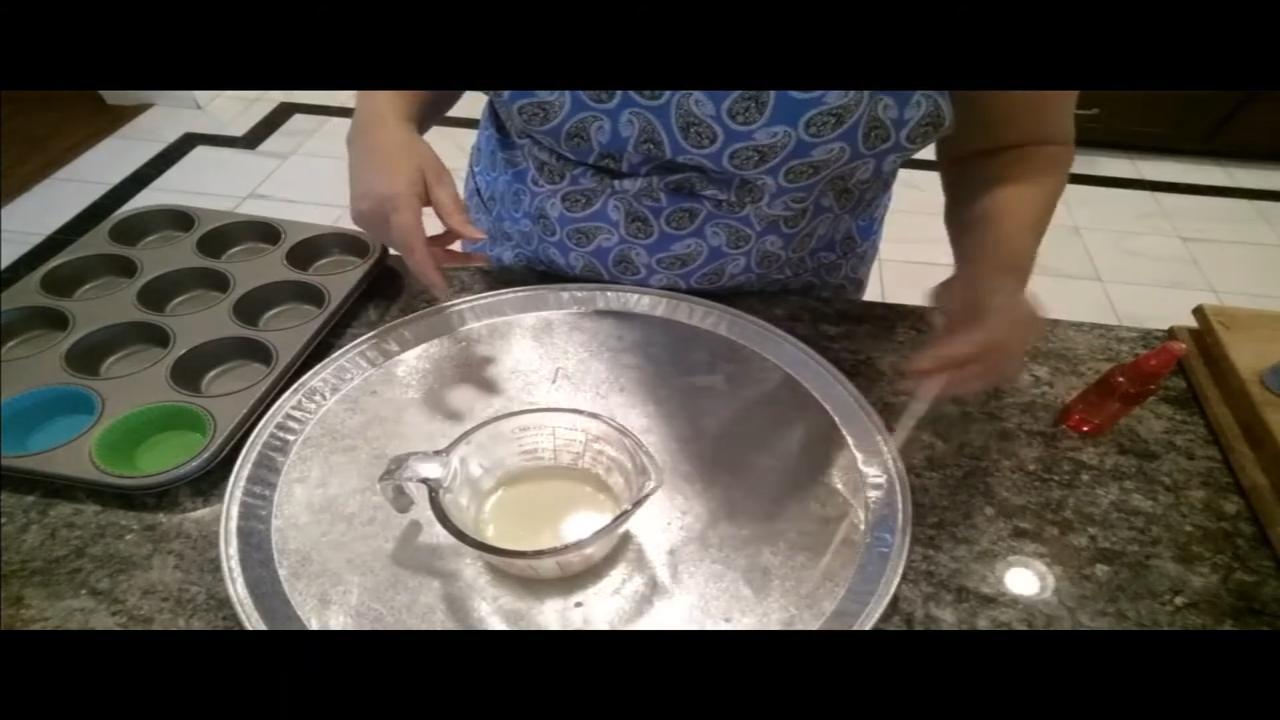 Pouring yellow soap into silicone cupcake cups