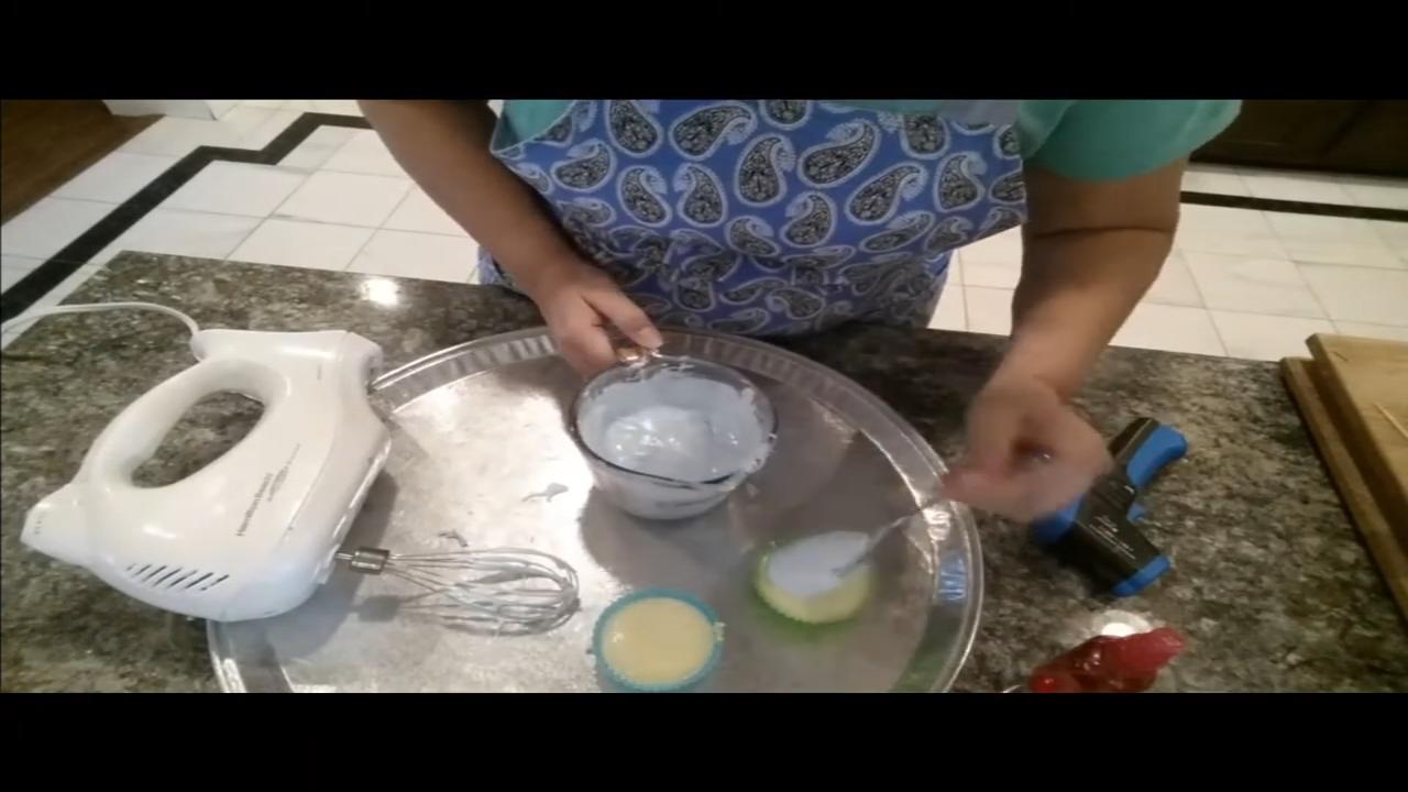 Spooning whipped aqua soap onto a cupcake soap