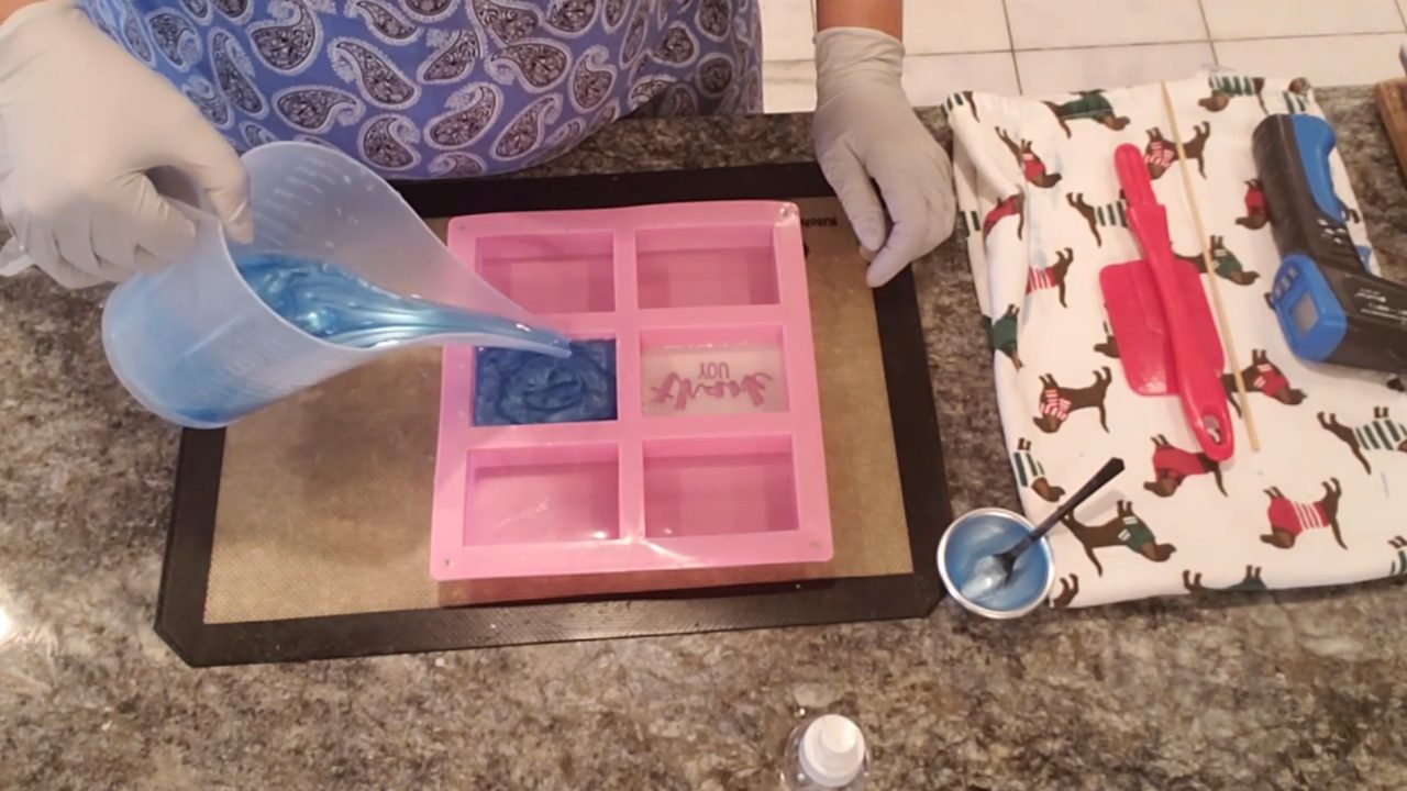 Blue soap layer filling the mold over the stamps