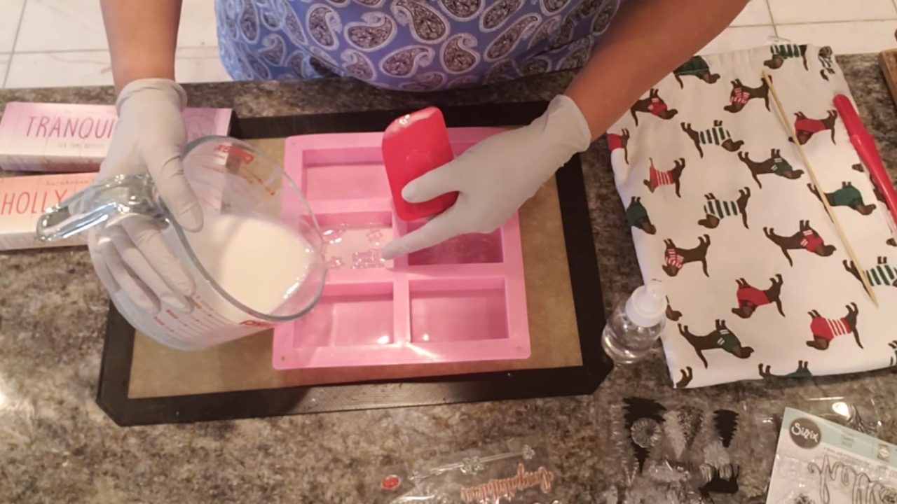 Spreading soap into the stamp details with a small spatula