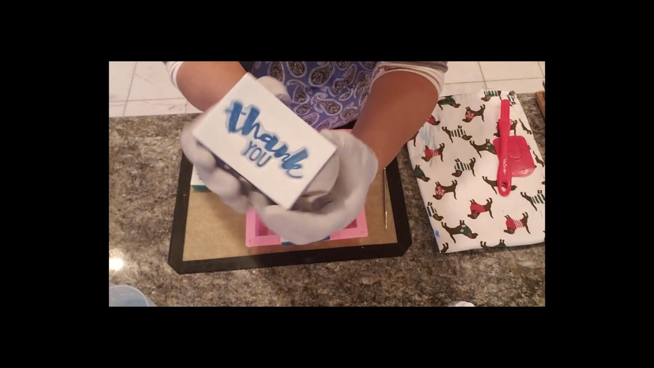 Stamped soap bar with a white design on blue