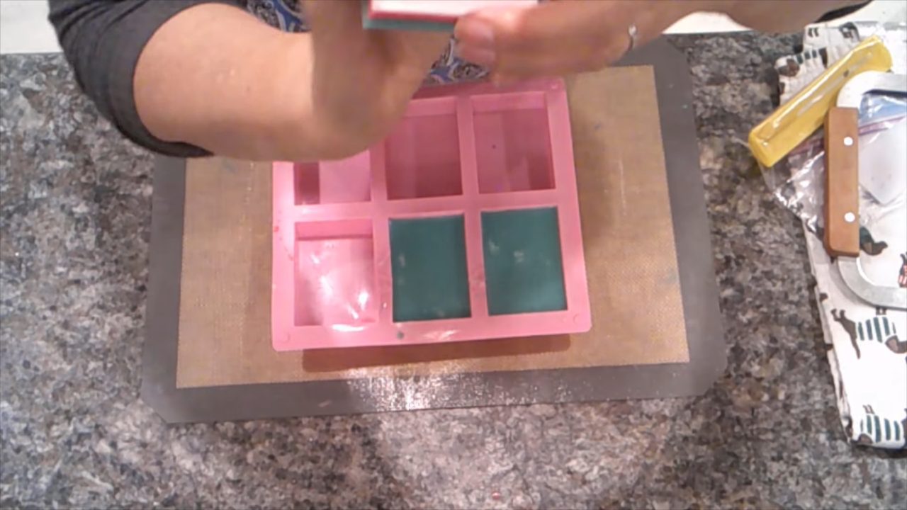 Unmolding Snowflake Bakery picture soaps from the mold