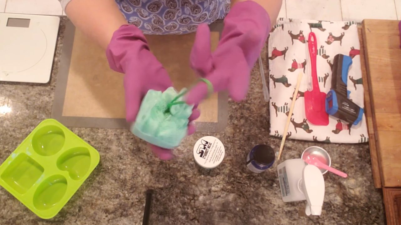 Finished soap on a rope with a green shower sponge set into melt and pour soap
