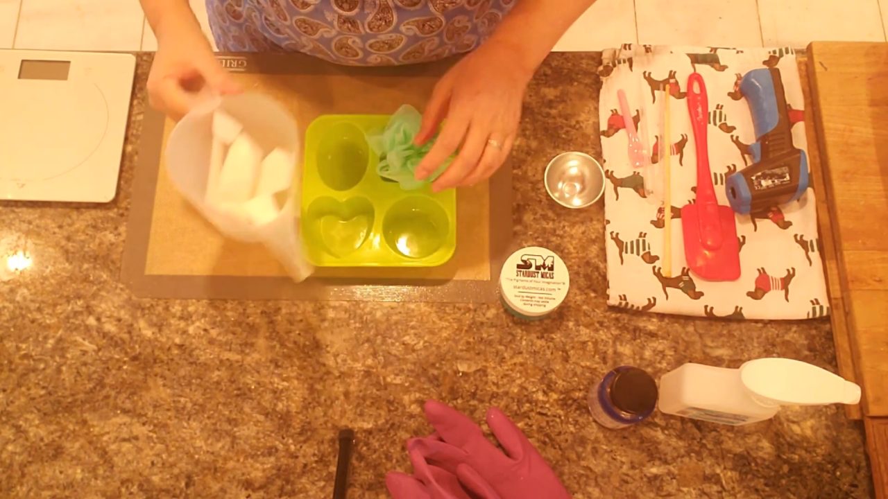 Shea butter melt and pour soap base next to a large silicone mold and shower sponges