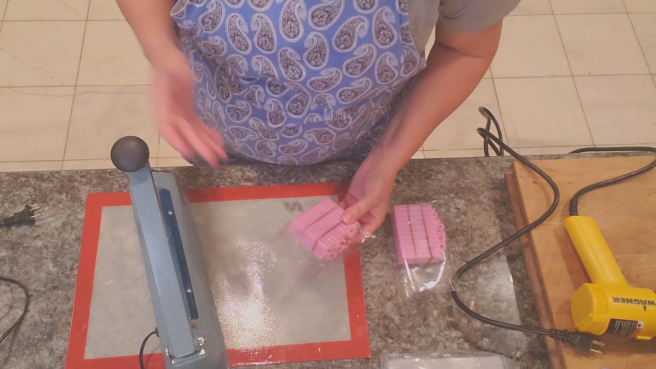 Sealing a shrink wrap bag around soap with an impulse sealer
