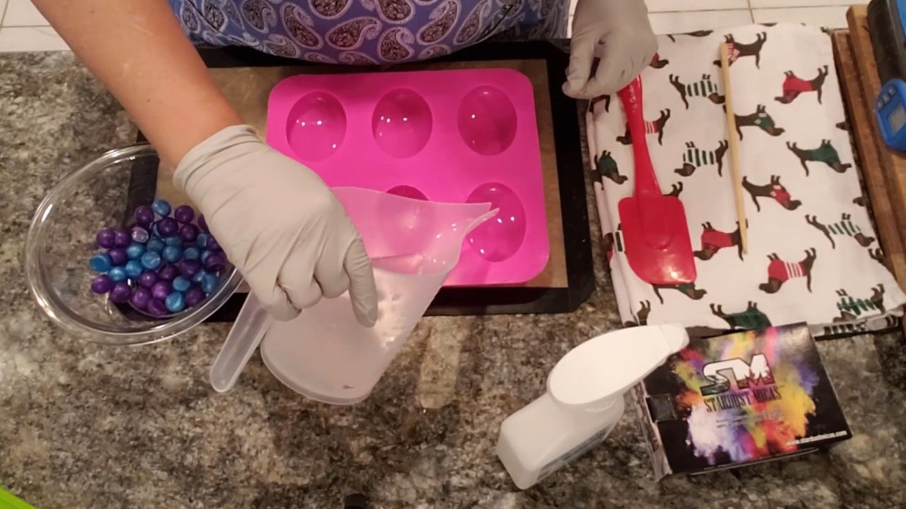 Pouring a little clear melt and pour soap into an oval mold