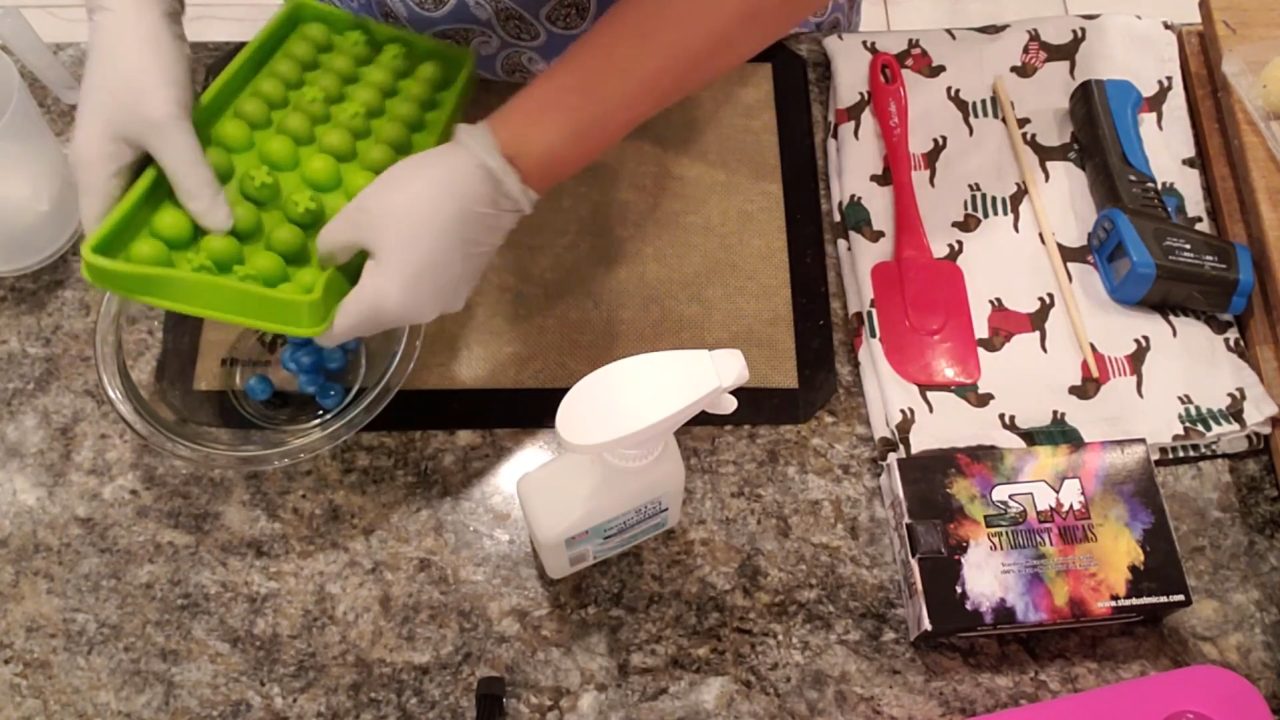 Popping blue and purple soap ball embeds out of the mold