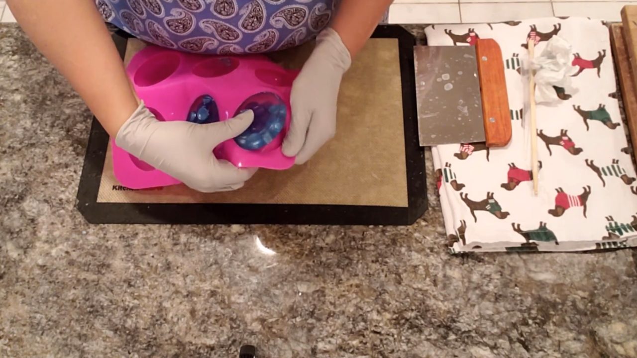 Unmolding a sphere embed soap with balls suspended in clear soap