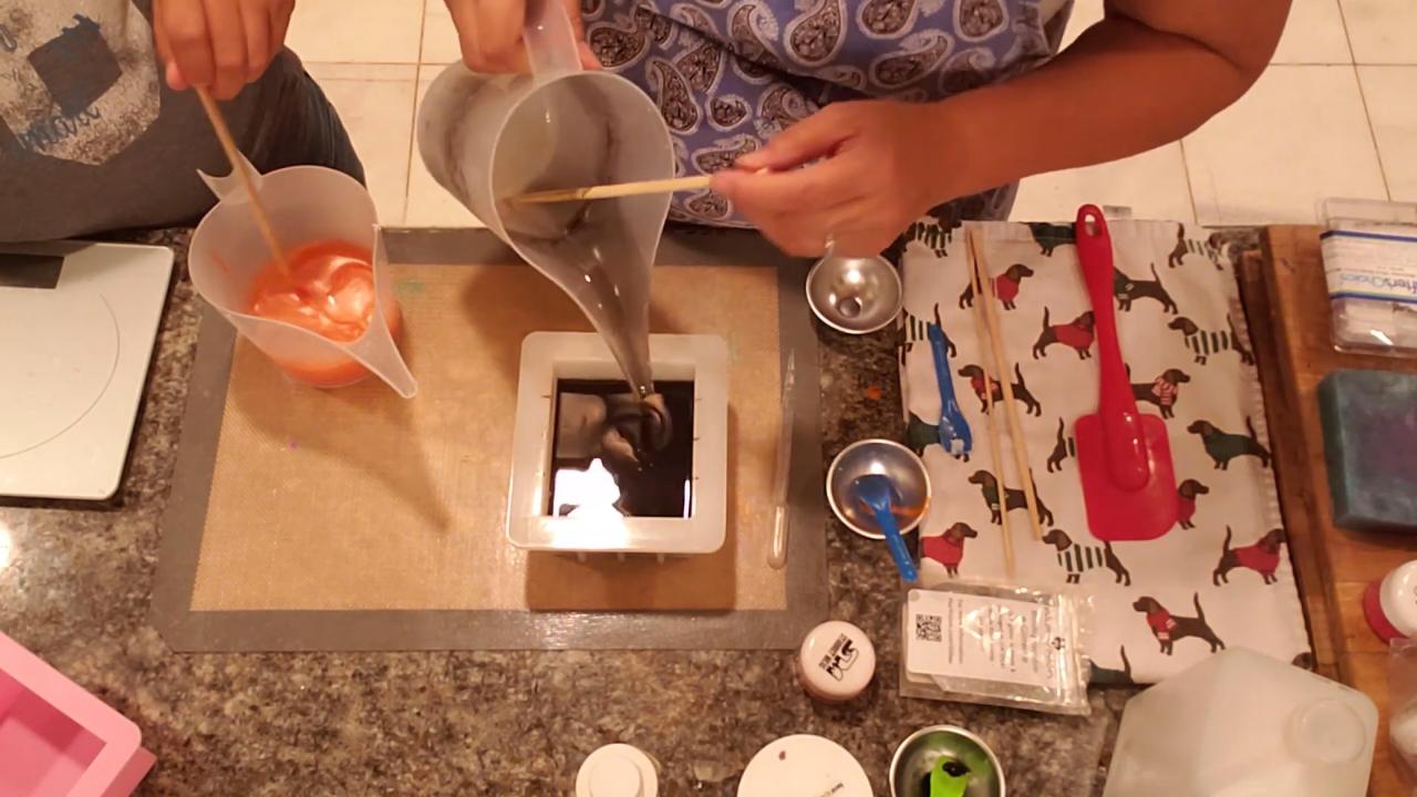 Pouring charcoal black soap into the mold