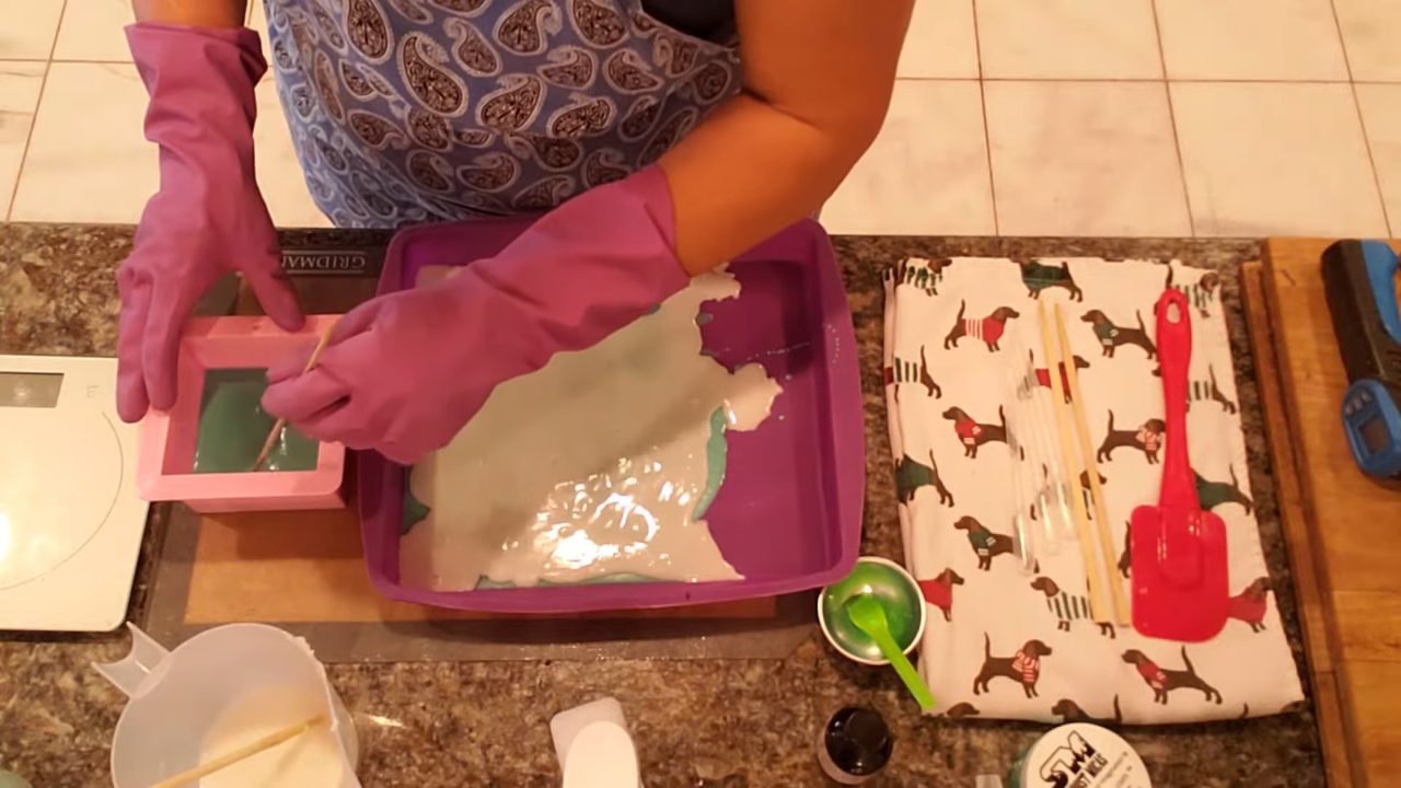Thin white soap layer poured over the green soap slab