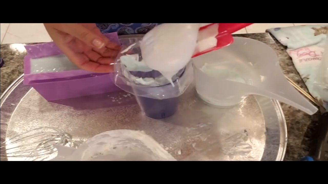 Folding green and purple mica into Melt Whip and Pipe frosting