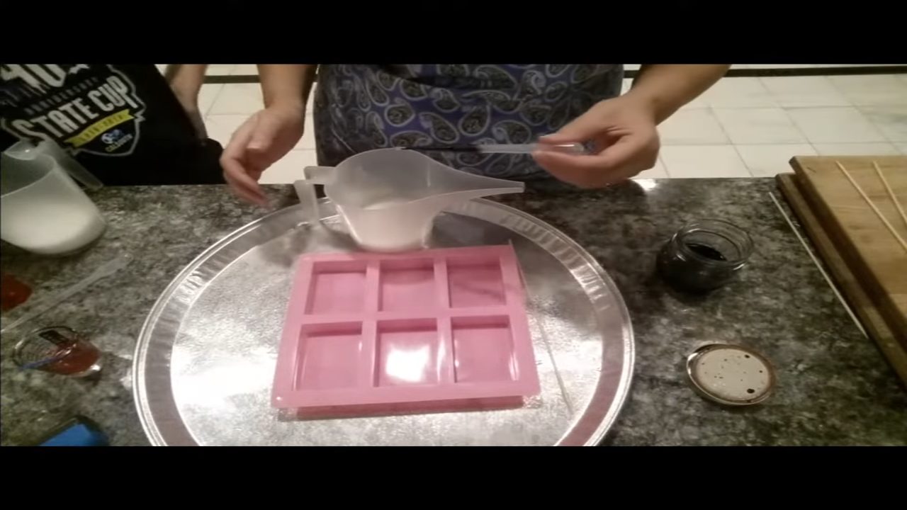 Squirting liquid color into cooled melt and pour soap with a pipette
