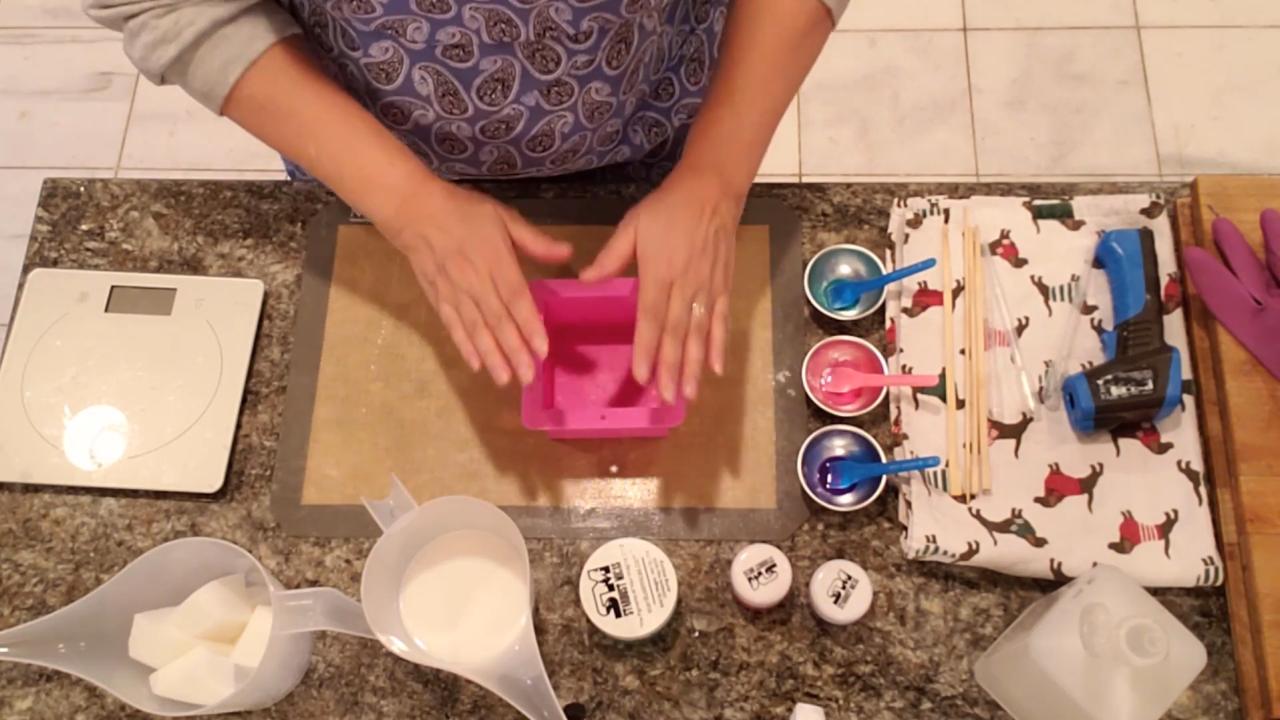 Dropping mica color into a square soap mold with a pipette