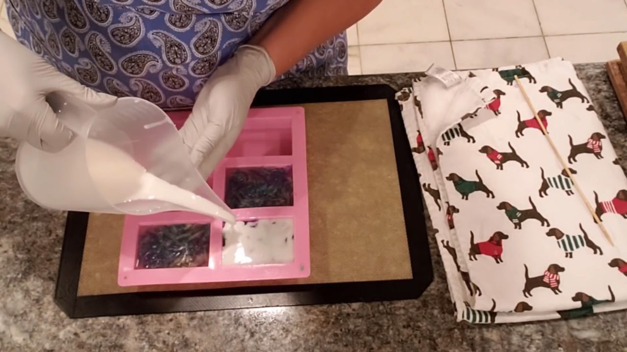 Pouring a thin white shea butter layer on the back of the shavings soap