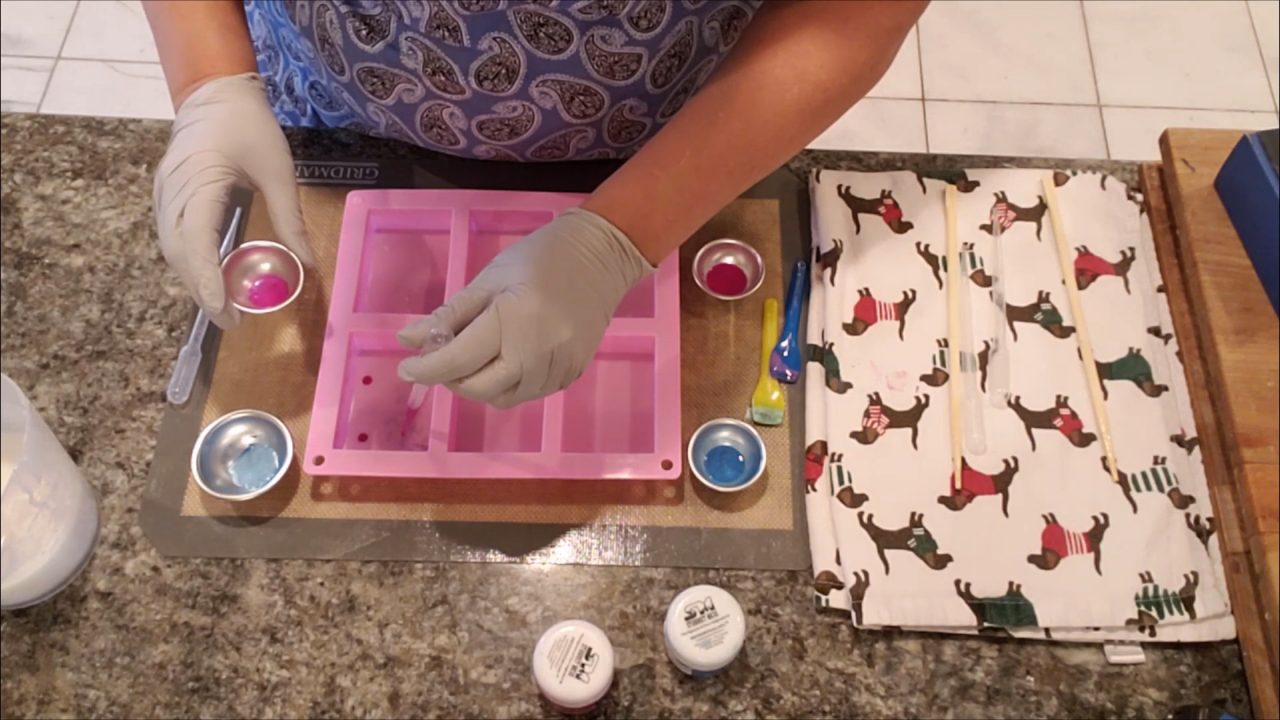 Dropping pink and blue mica into the empty mold cavities