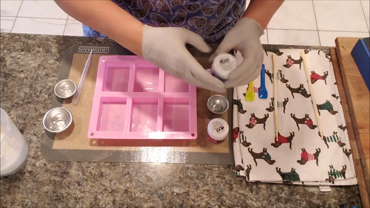 Mixing pink and blue mica in distilled water and alcohol for tie dye soap