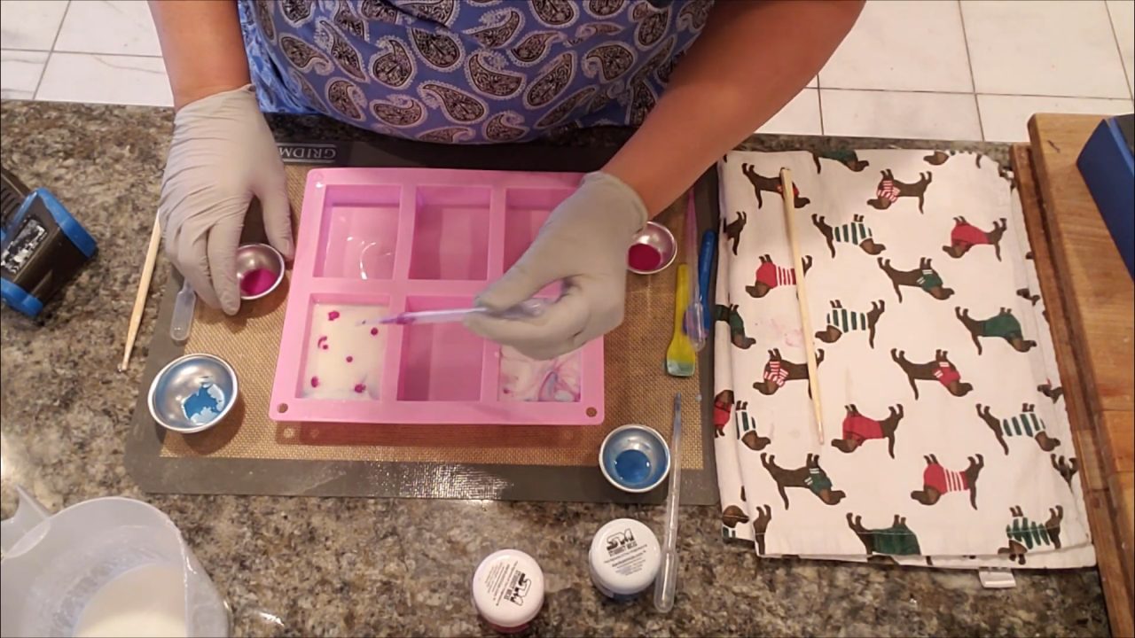 Swirling tie dye colors in the soap with a skewer