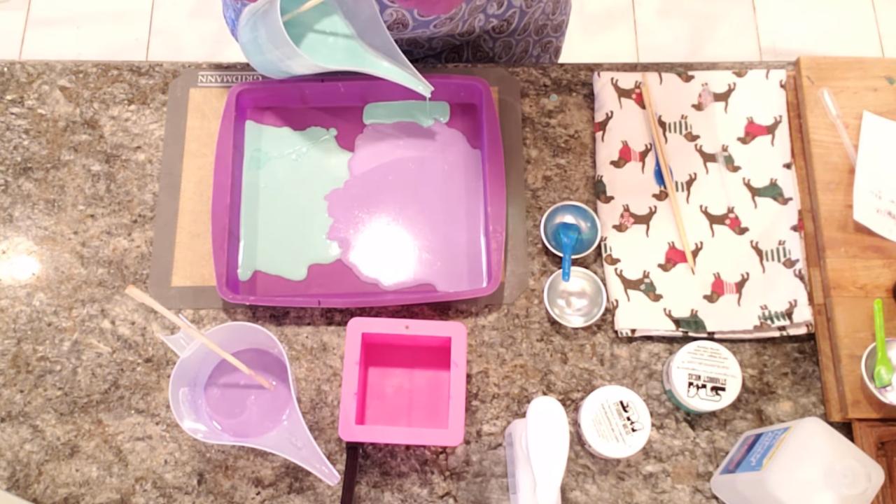 Green soap flowing around the purple in the pan