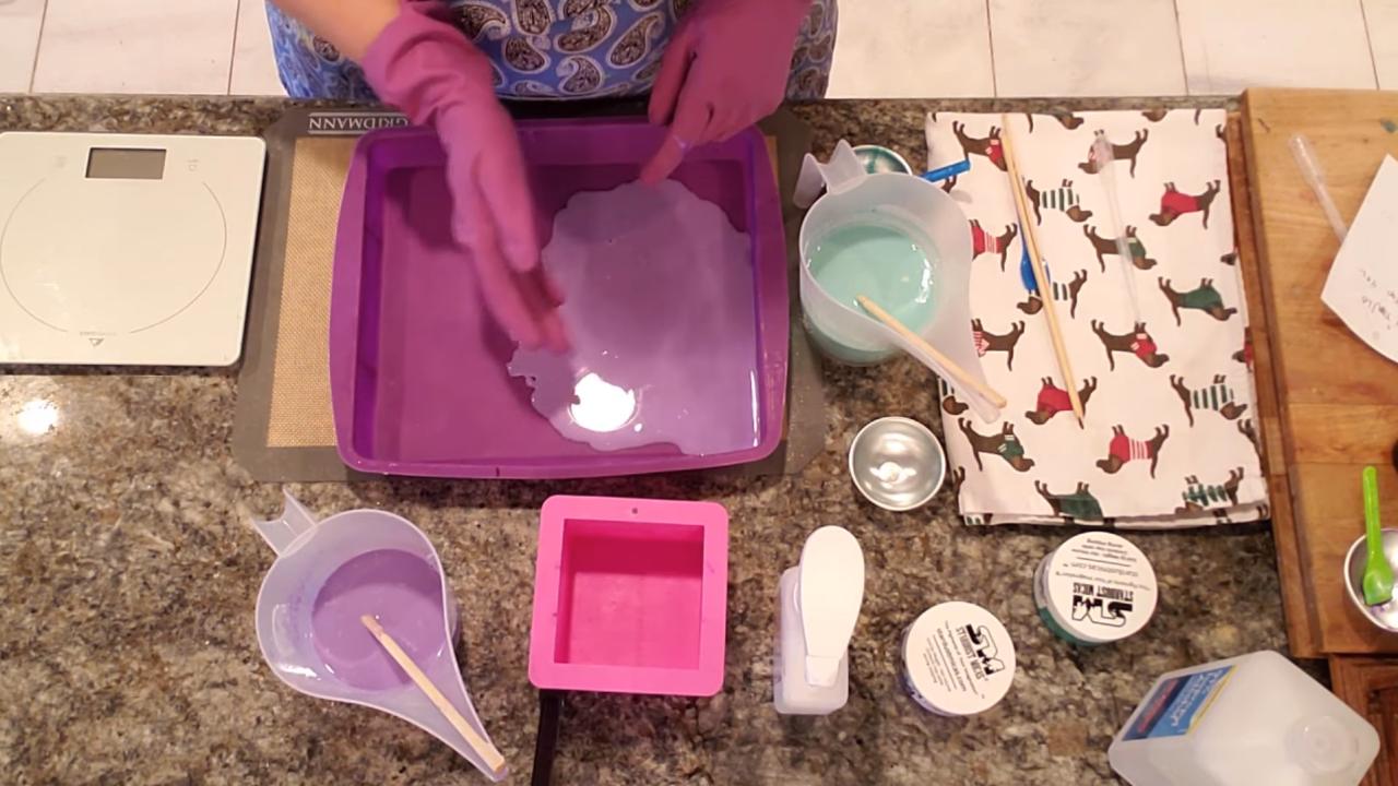 Pouring teal green soap on the side of the purple