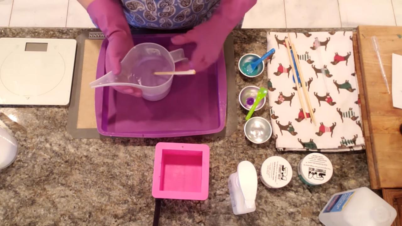 Pouring purple soap into a silicone pan