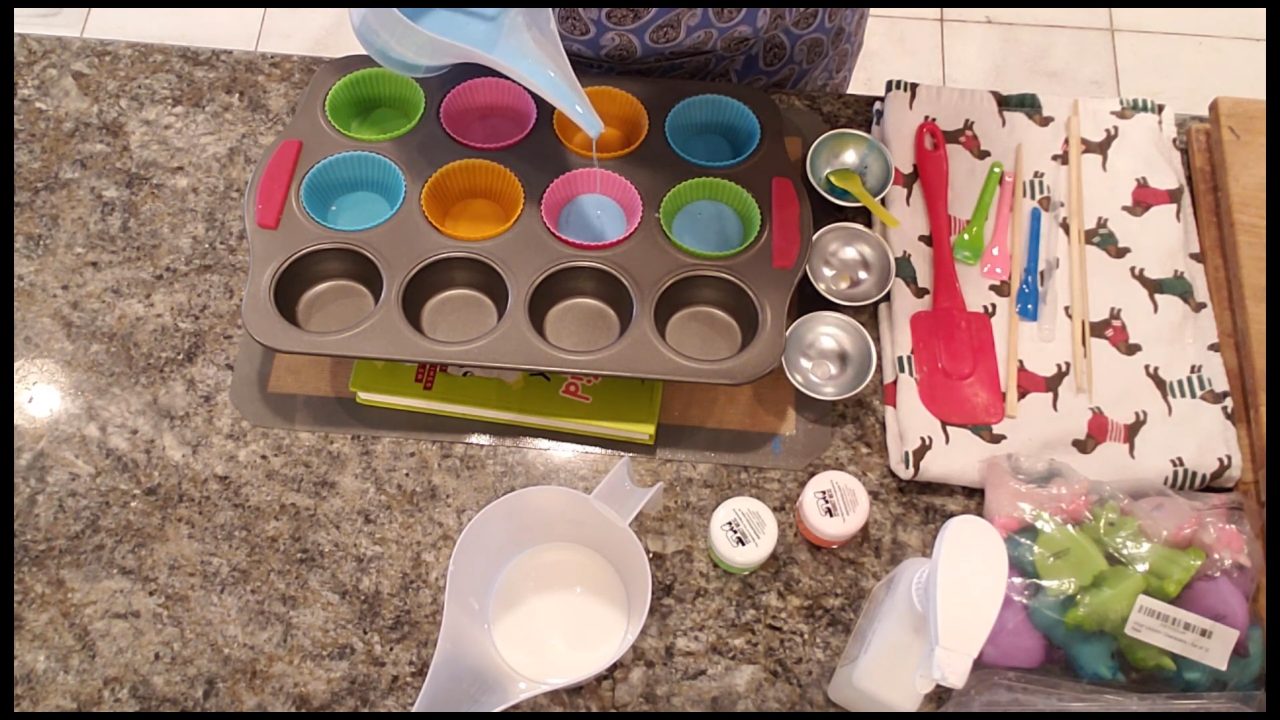 Silicone cupcake liners tilted at an angle with neon blue soap