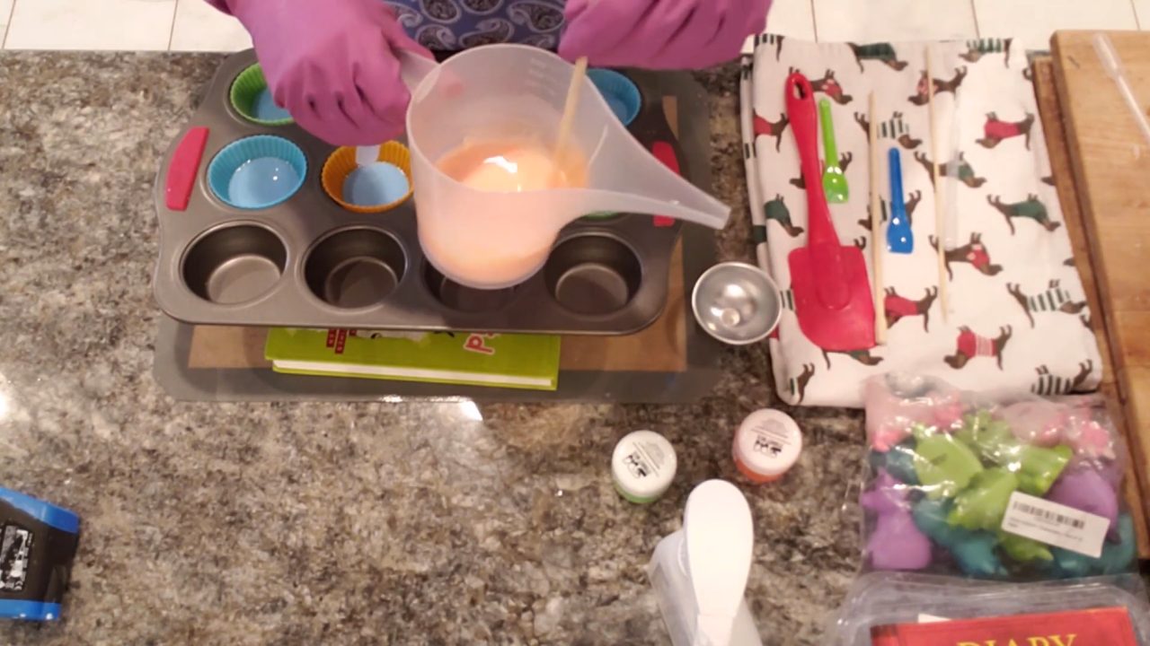 Pouring neon orange soap into the angled cupcake liners