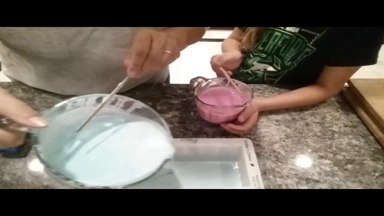 Pouring a stripe of green soap into the mold