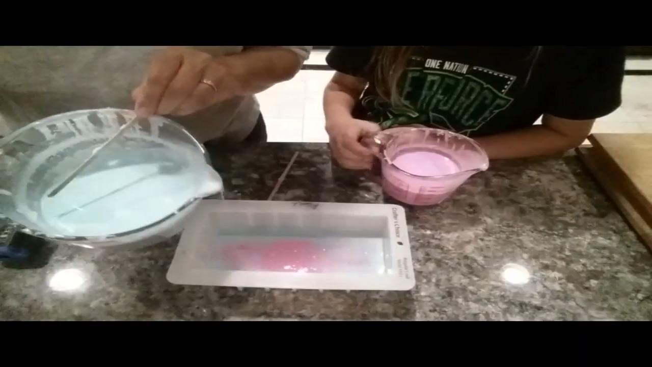 Pouring pink soap stripes into the mold