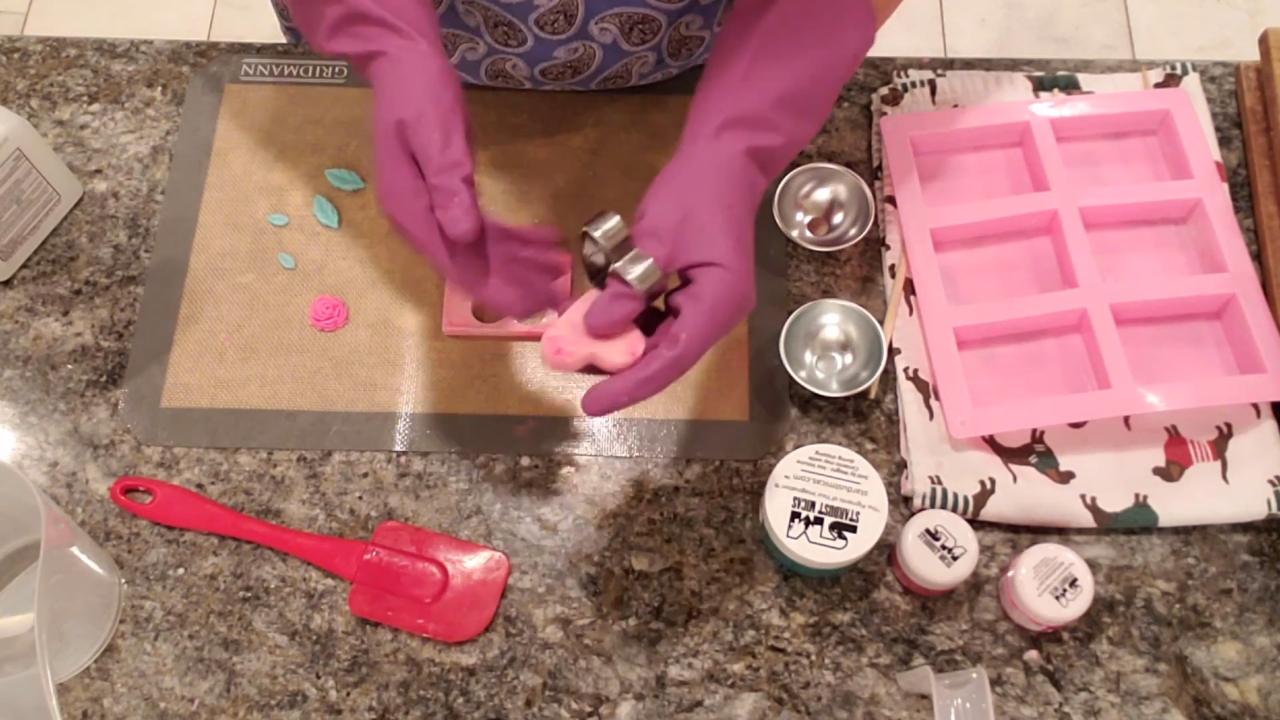 Placing a rose embed into the heart window of the soap