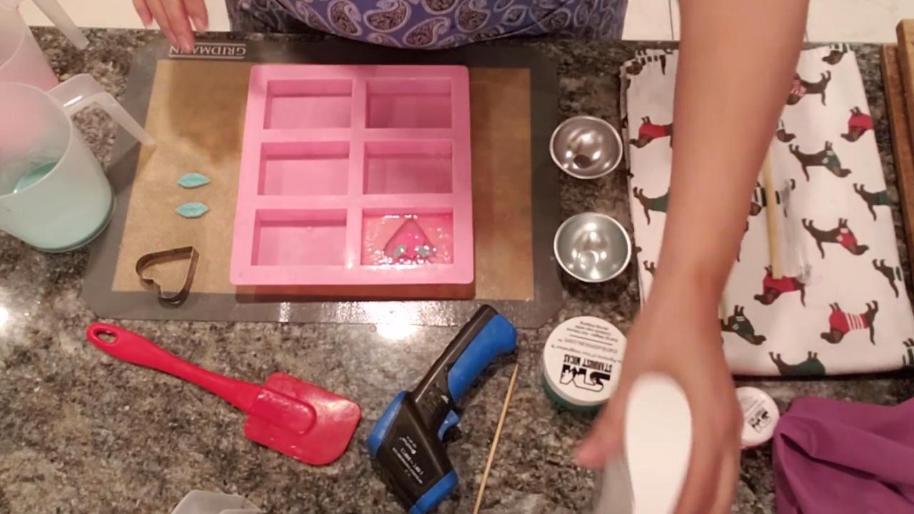 Pouring a swirled pink and green back on the Valentine soap