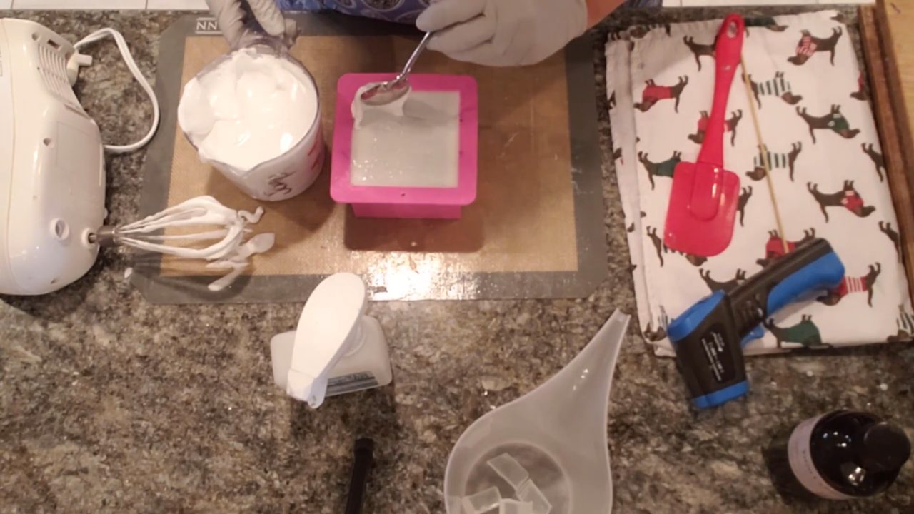 Spooning whipped soap frosting on top in waves