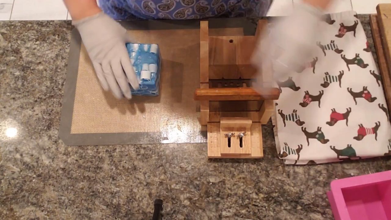 Trimming the sides of the soap curl insert with a soap cutter