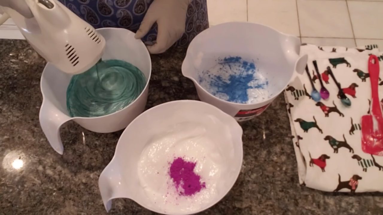 Whipping colored whipped soap base with a hand mixer and whisk