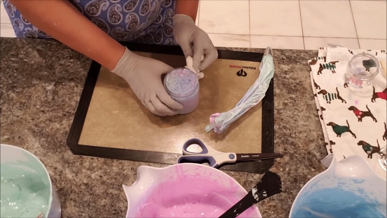 Piping multicolor whipped soap into a jar
